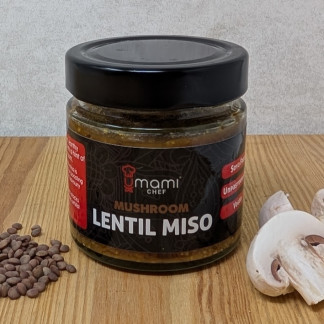 Jar of lentil miso showing the green lentils and mushrooms used to create it